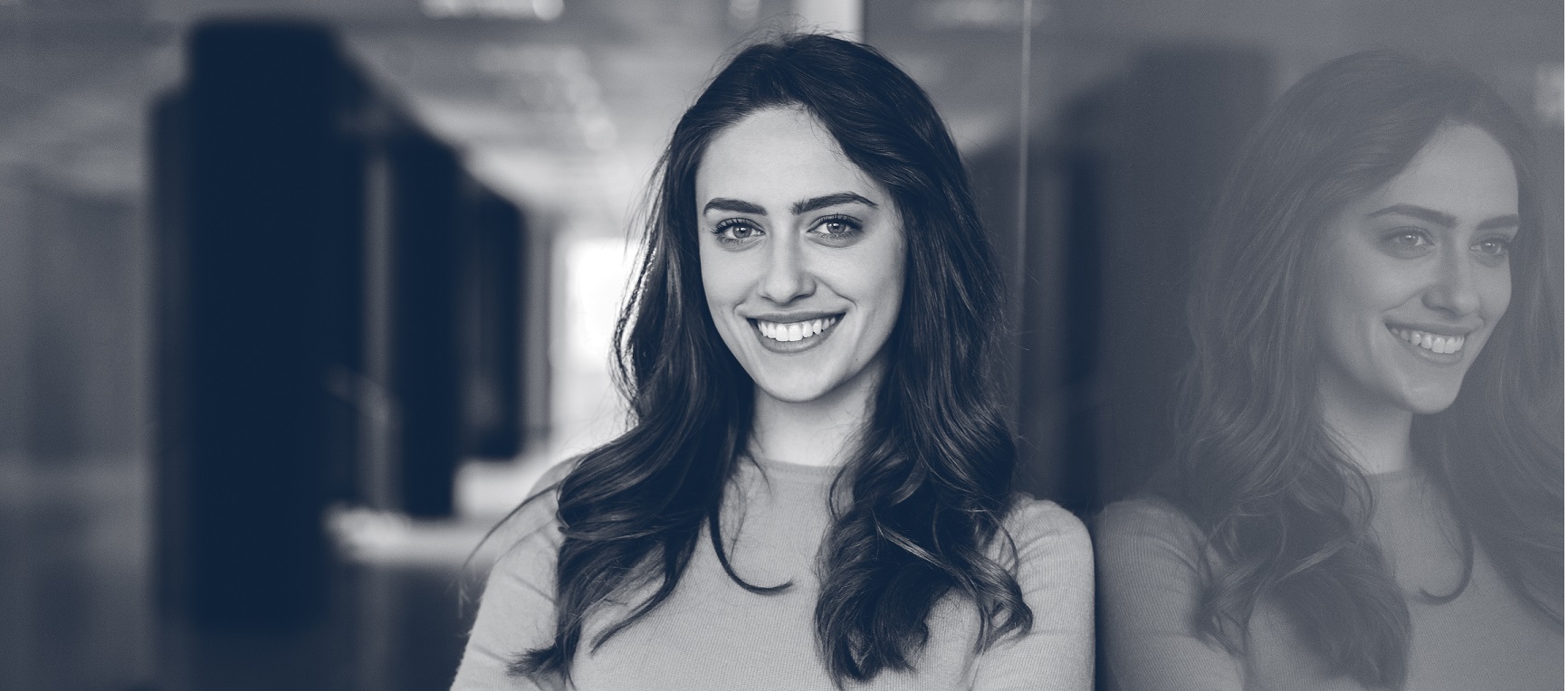 Smiling woman in the office looking at camera